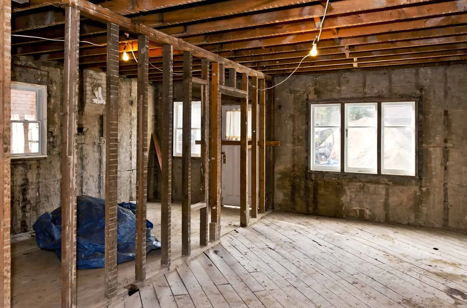 Gutted room with exposed studs during an interior demolition
