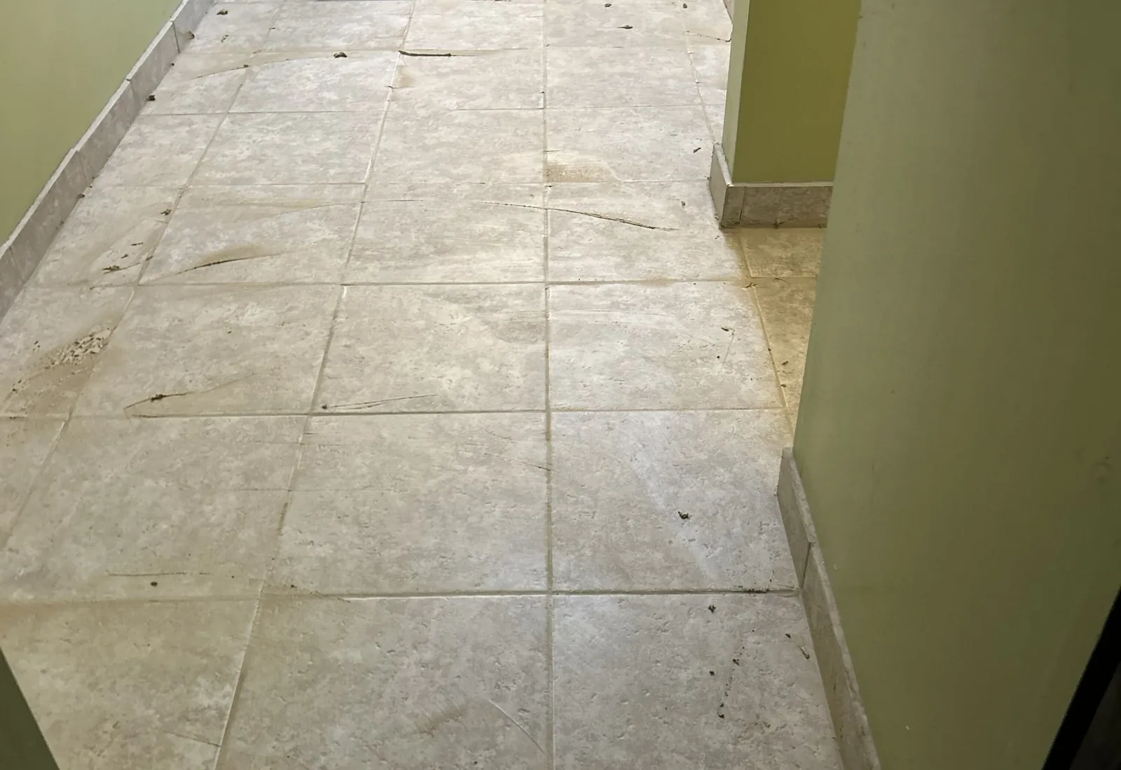 Finished large-format tile hallway floor in a remodeled home